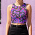 Honey Dazed Brand body-hugging racerback crop top featuring Y2K-inspired print with purple gradient cherries, holographic bows, and swirling patterns in pink, purple, and blue on black background in performance knit fabric